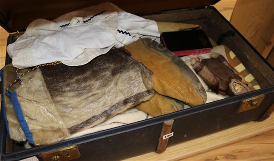 A quantity of Canadian Arctic parkas, sealskin boots, dolls, kayak, etc.